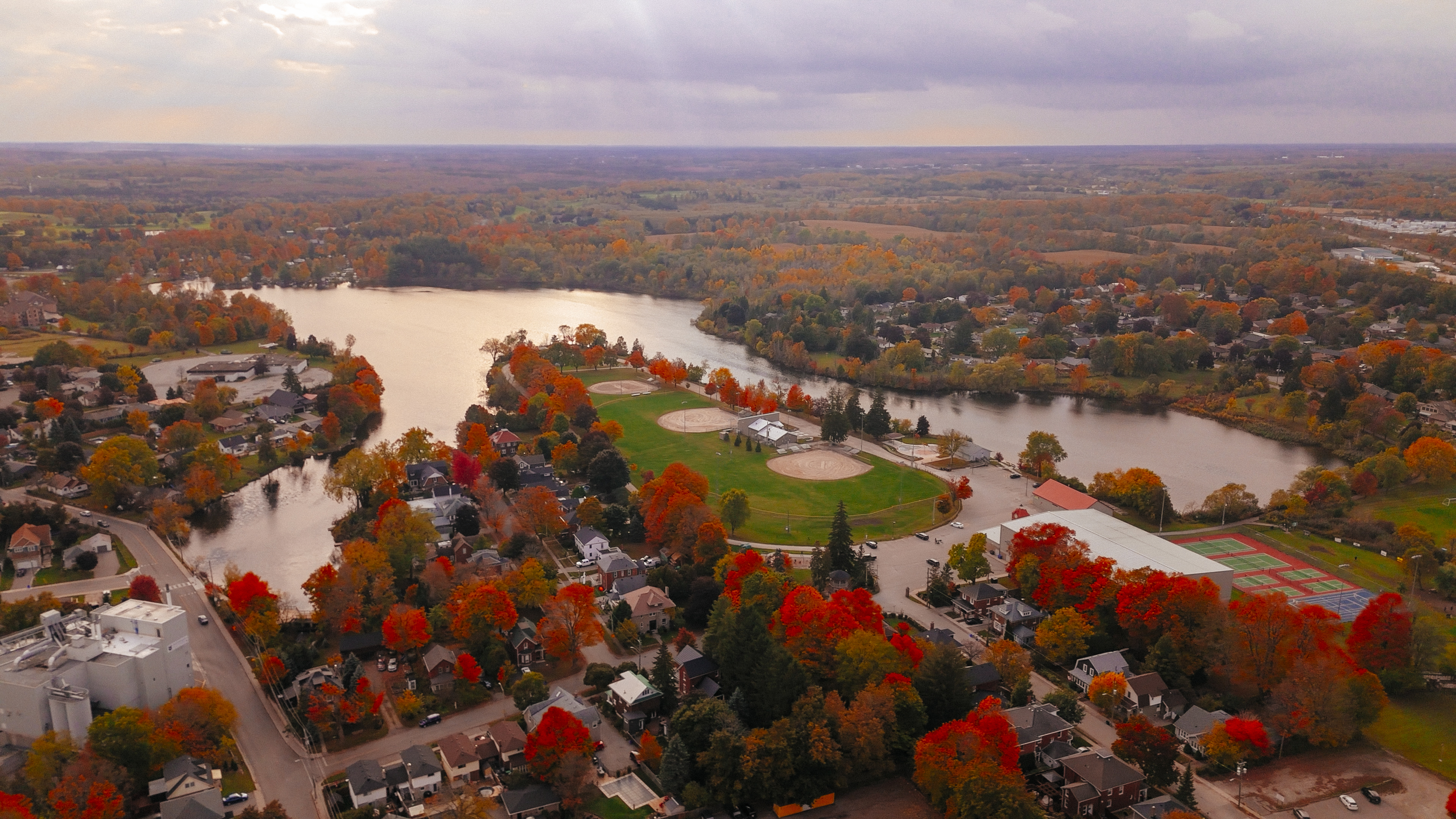 an aerial image of fairy lake in Acton. In the photo you can see the lake surrounded by houses and all the foliage is turning red and orange