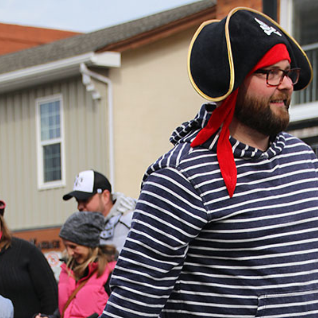 a man dressed as a pirate walking down the street