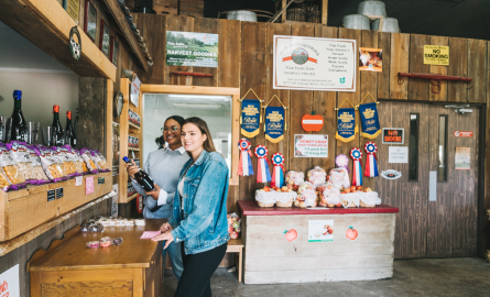 Two women at a farm store looking at some of the products